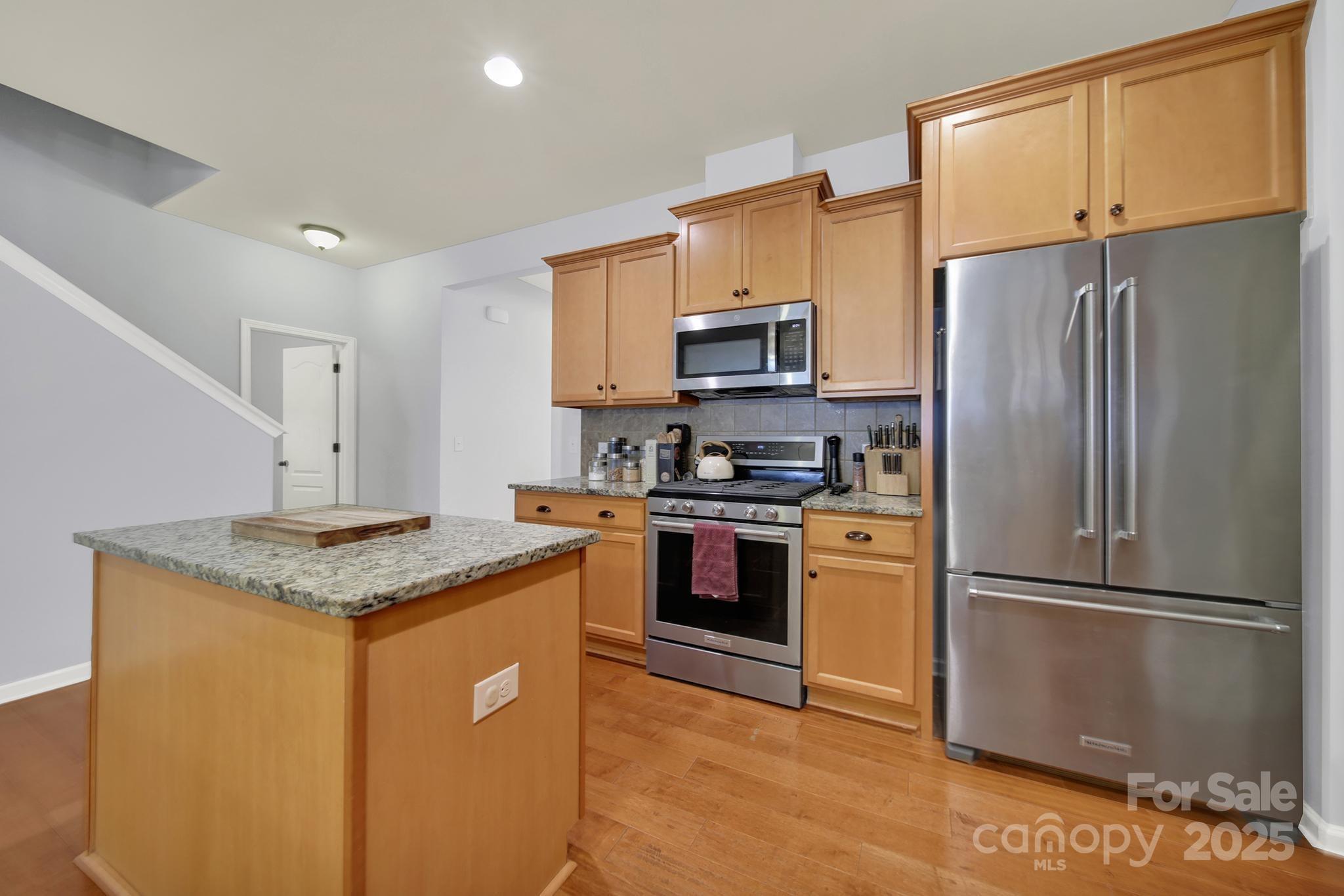 1726 Still River Way Fort Mill, SC 29708 - Photo 19 of 45 a kitchen with stainless steel appliances granite countertop a refrigerator stove a sink and dishwasher