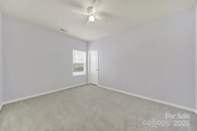 a view of an empty room with a fan