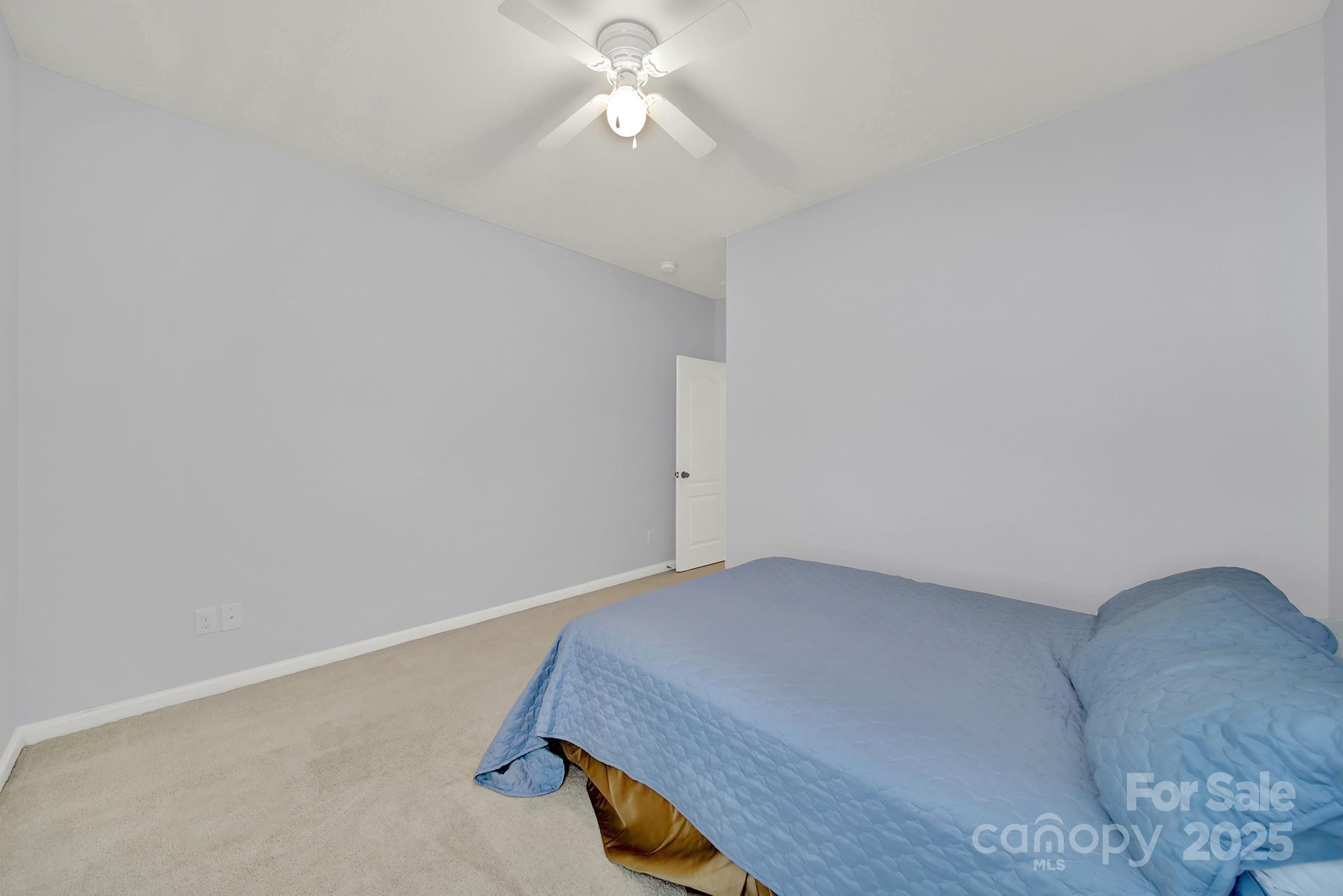 1726 Still River Way Fort Mill, SC 29708 - Photo 31 of 45 a bedroom with a bed and a chandelier fan