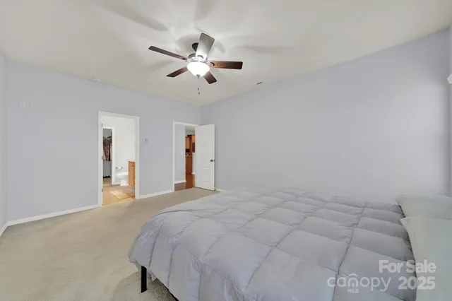 a bathroom with a granite countertop sink a toilet and a mirror