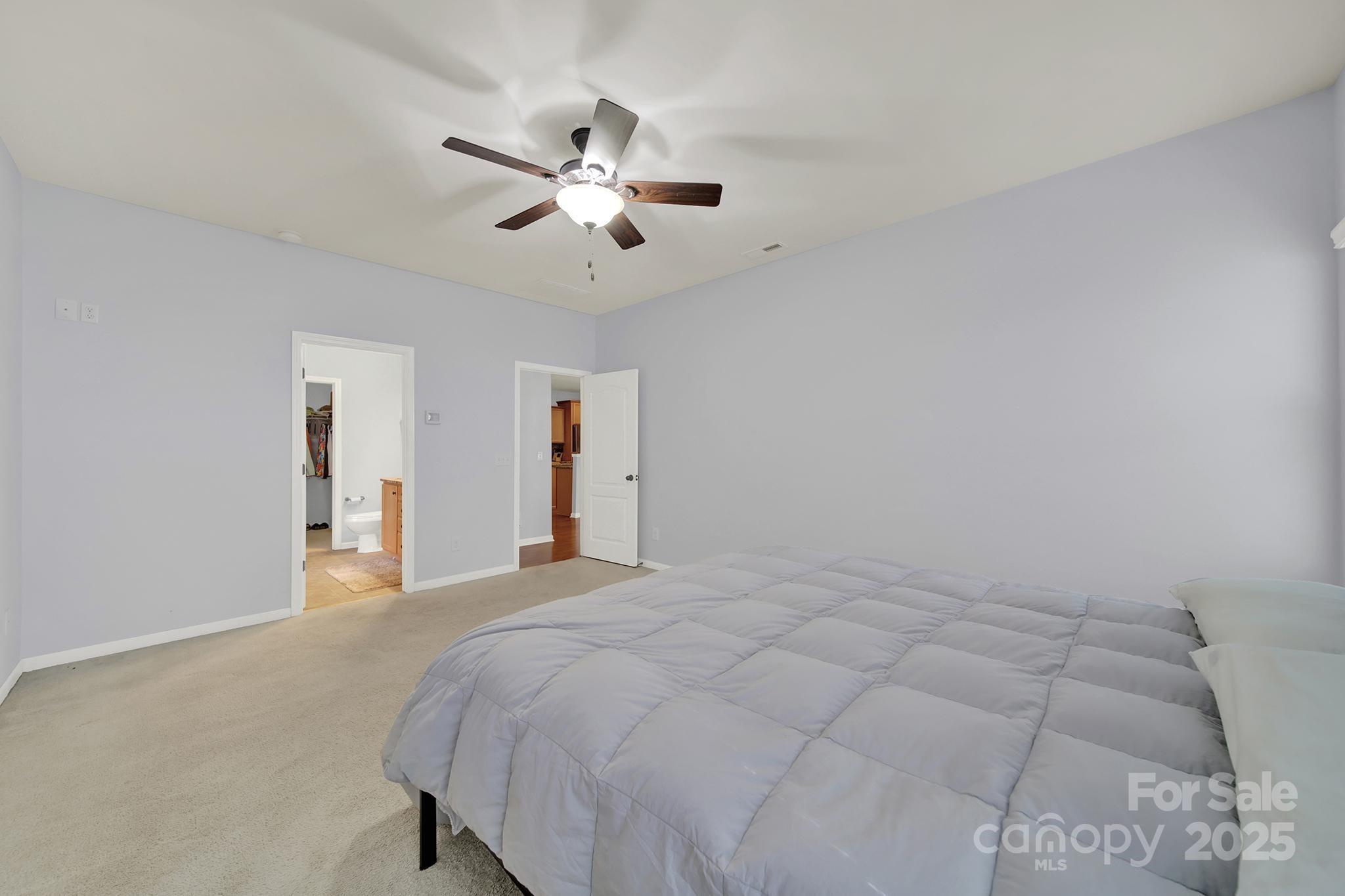 1726 Still River Way Fort Mill, SC 29708 - Photo 33 of 45 a spacious bedroom with a bed and a chandelier