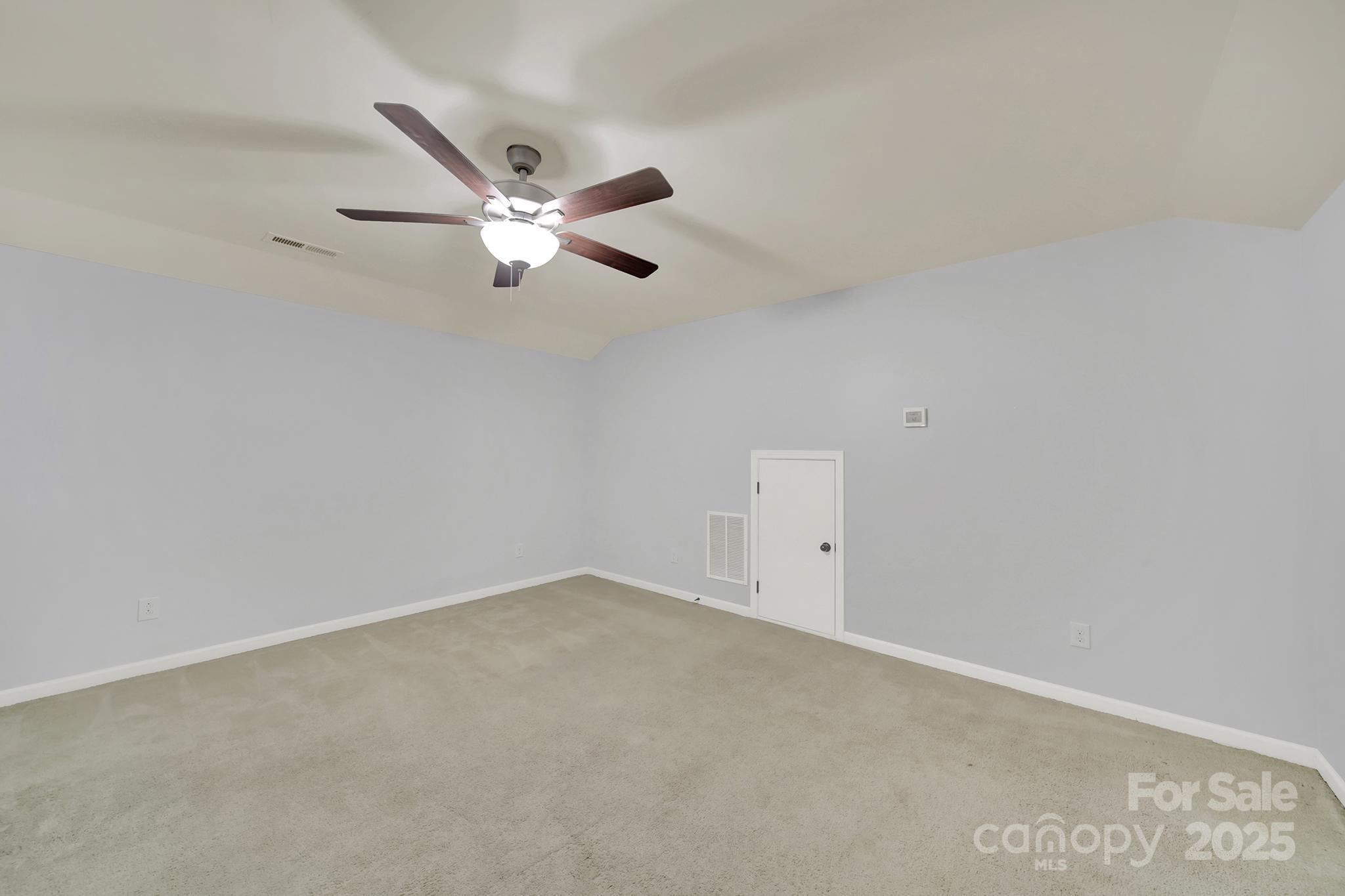 1726 Still River Way Fort Mill, SC 29708 - Photo 37 of 45 an empty room with a window and a ceiling fan