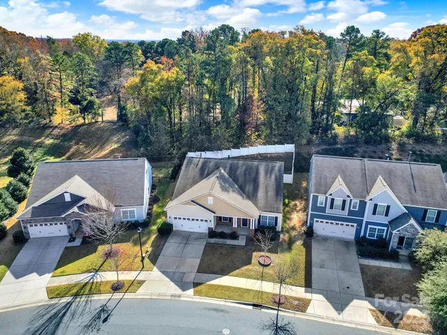 an aerial view of a house with swimming pool and sitting space