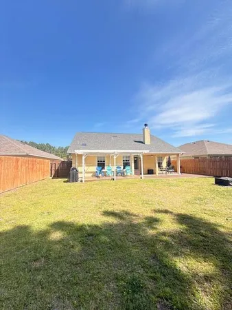 a front view of a house with a yard and swimming pool