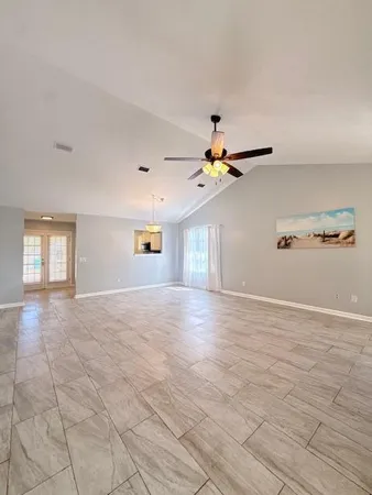 a view of a livingroom with a ceiling fan and window