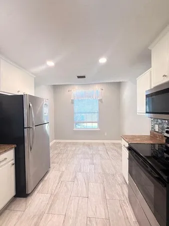a kitchen with a refrigerator and a sink