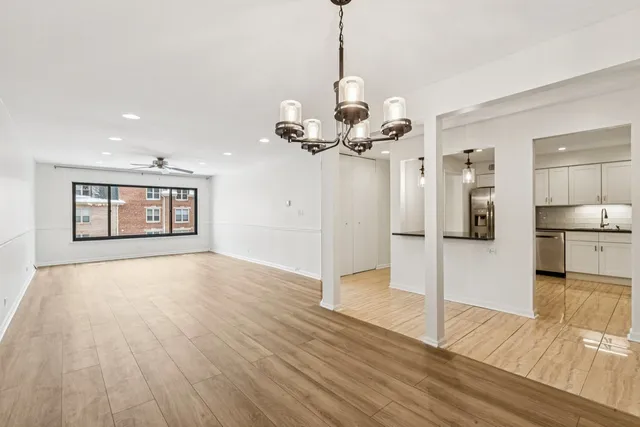 a view of a kitchen with wooden floor and a chandelier