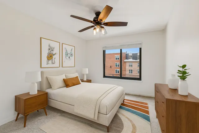 a bedroom with a bed window and couch