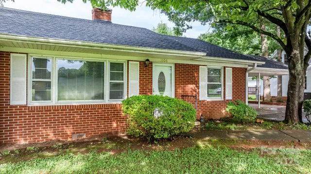 front view of a brick house with a large window
