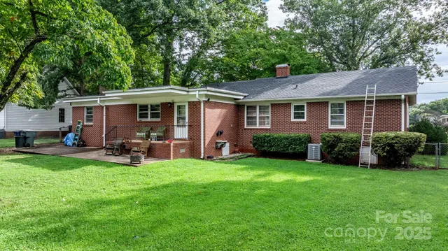 a view of a house with a yard and sitting area