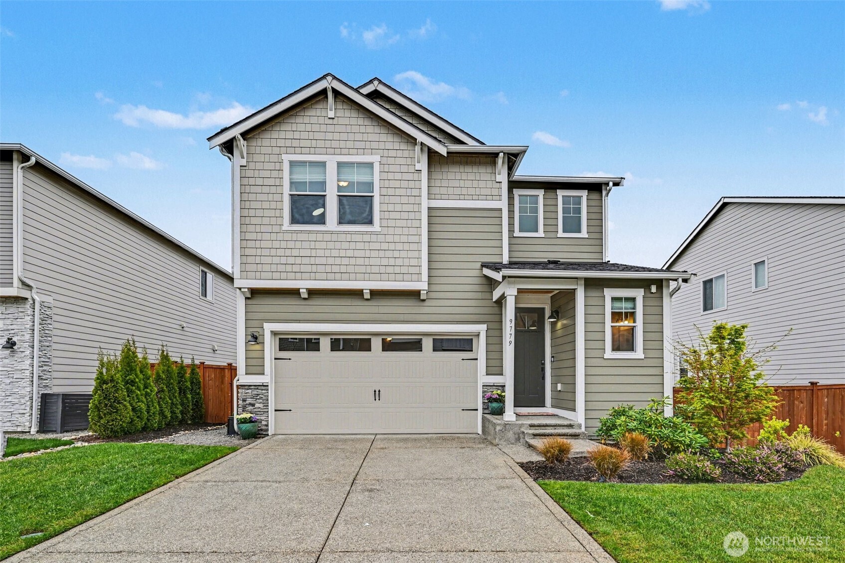 a front view of a house with a yard and garage