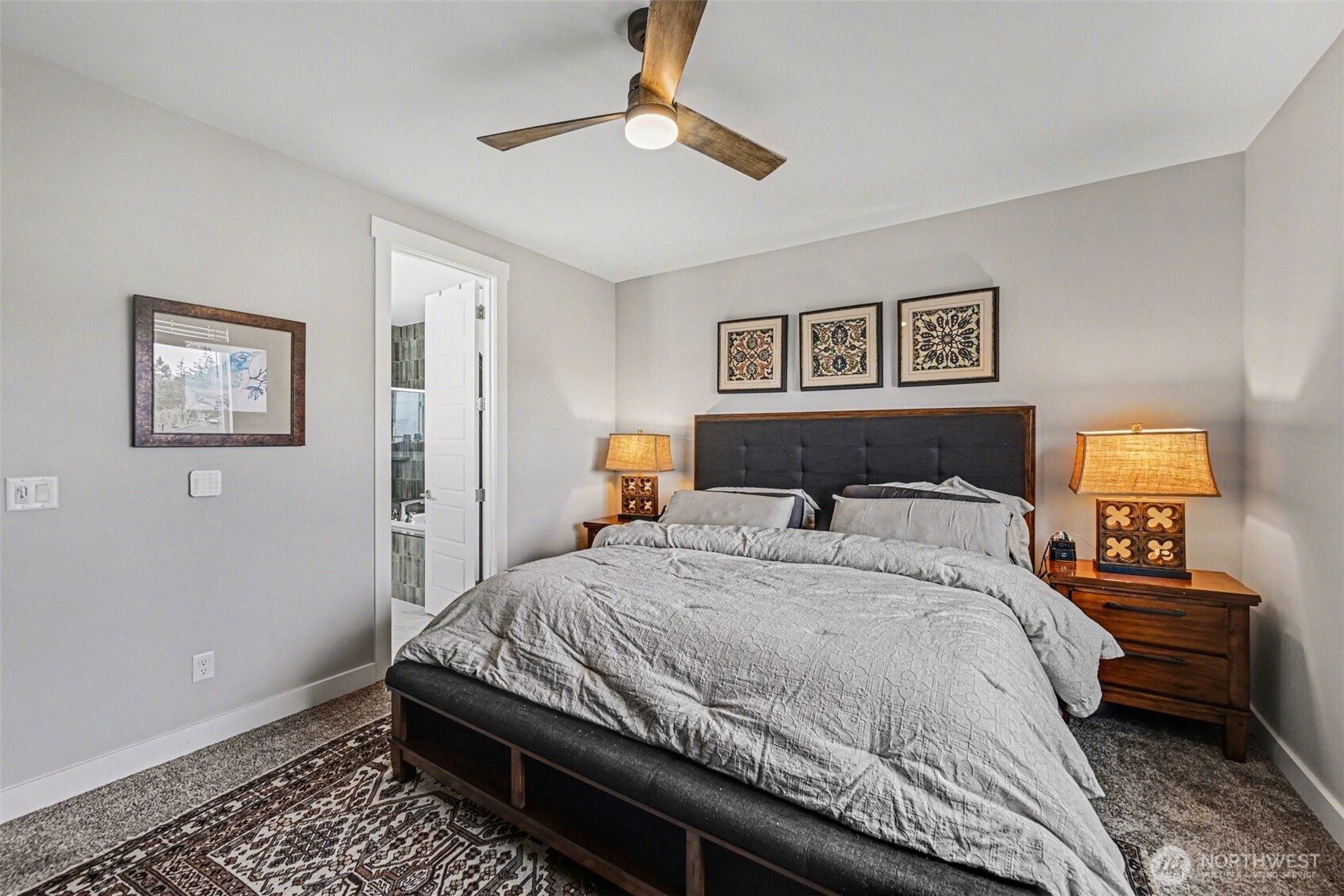 9779 Prospect Place Gig Harbor, WA 98332 - Photo 15 of 33 a bedroom with a bed and a chandelier