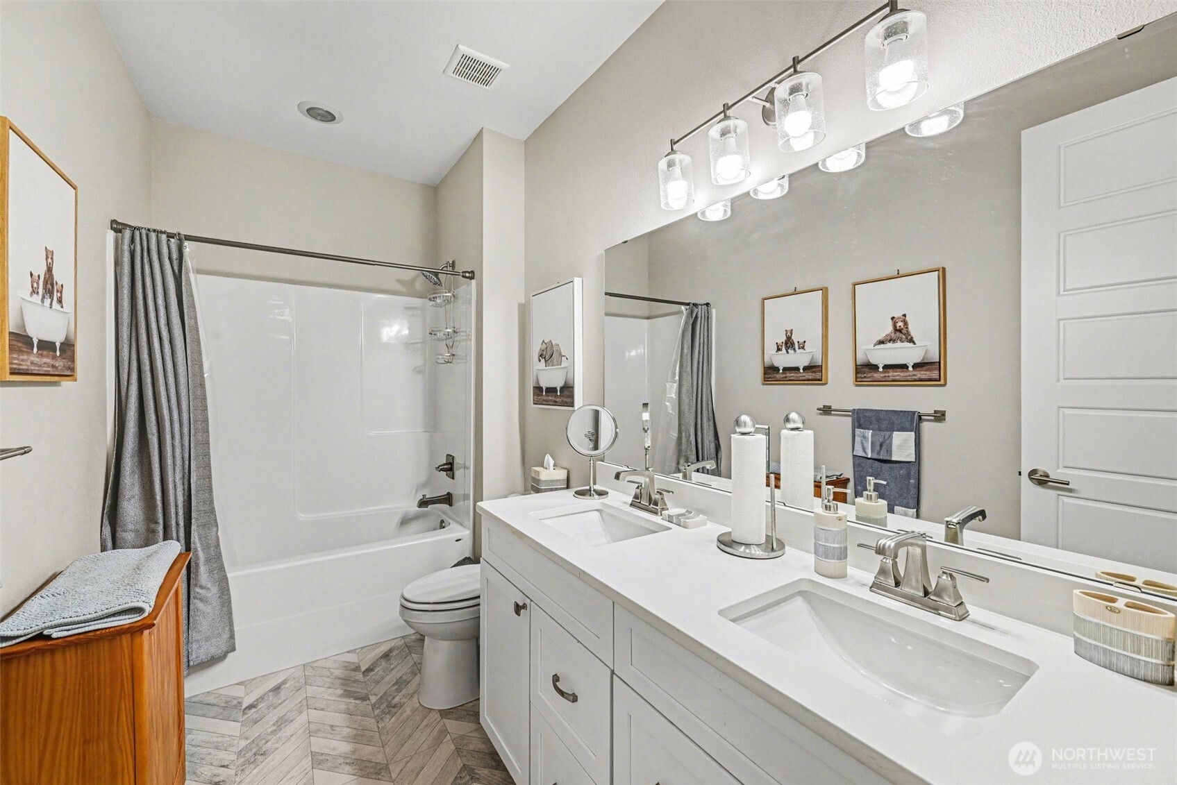 9779 Prospect Place Gig Harbor, WA 98332 - Photo 16 of 33 a bathroom with a sink a toilet and a large mirror