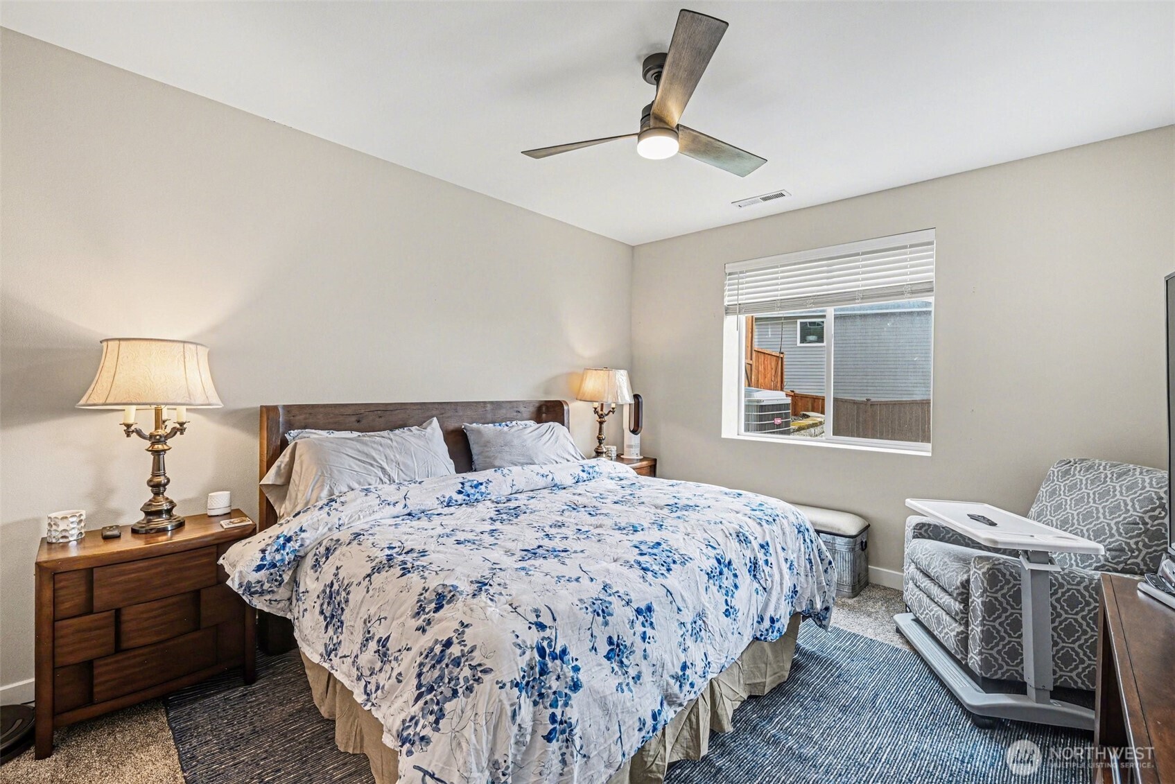 9779 Prospect Place Gig Harbor, WA 98332 - Photo 20 of 33 a bedroom with a bed and a chandelier