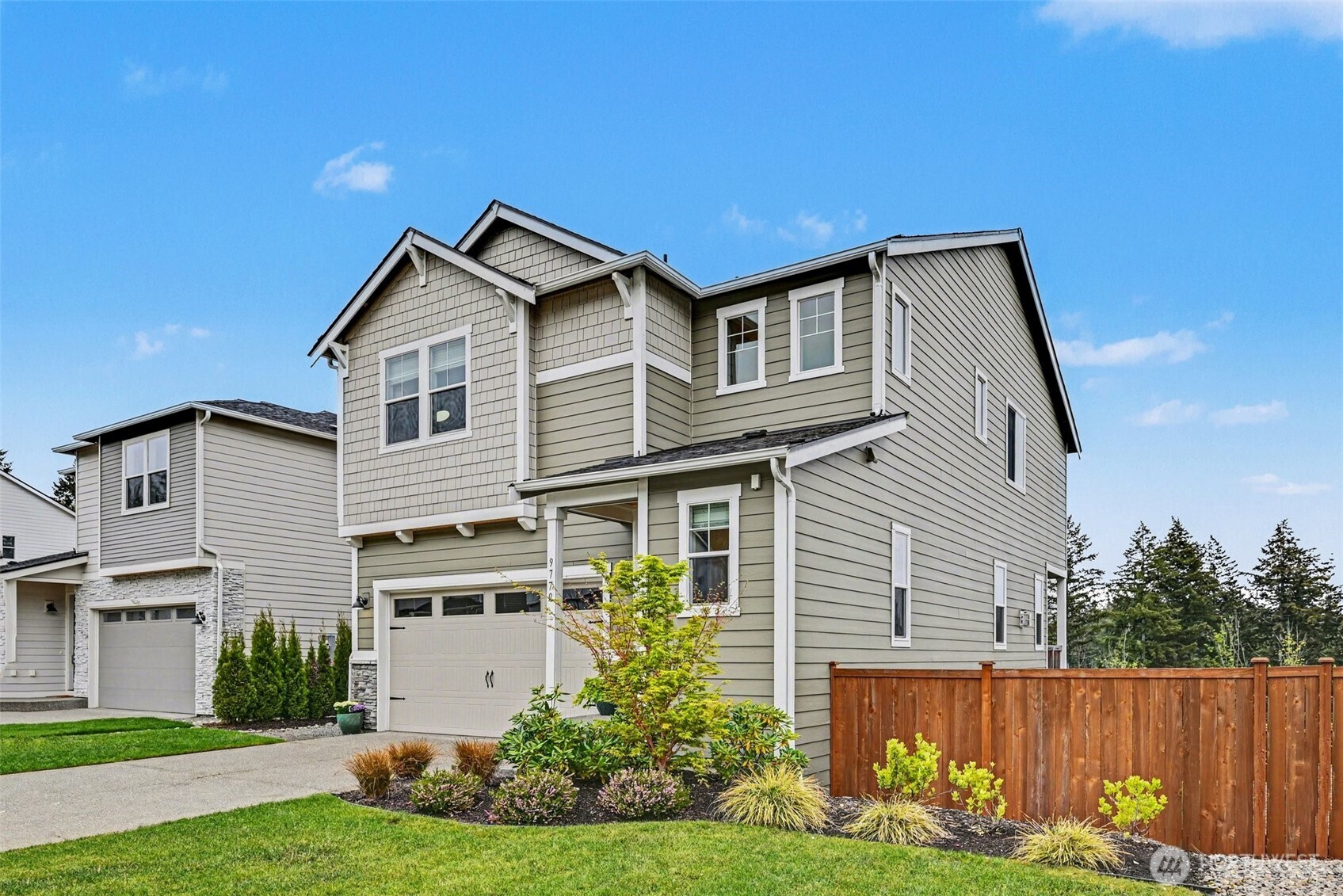 9779 Prospect Place Gig Harbor, WA 98332 - Photo 2 of 33 a front view of a house with a yard