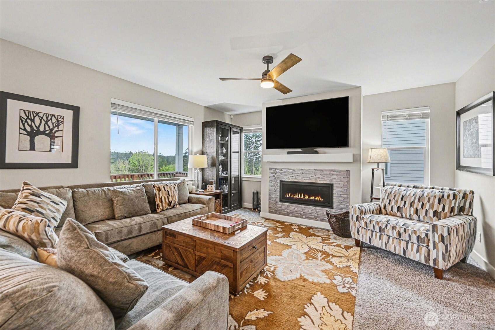 9779 Prospect Place Gig Harbor, WA 98332 - Photo 6 of 33 a living room with furniture a flat screen tv and a fireplace