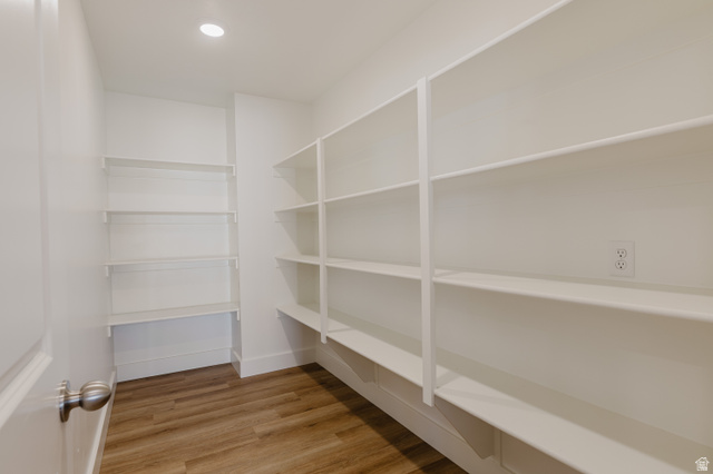 433 North 600 West Smithfield, UT 84335 - Photo 15 of 40 Spacious pantry featuring extensive white shelving, wood-finish flooring, recessed ceiling lighting, and an electrical outlet