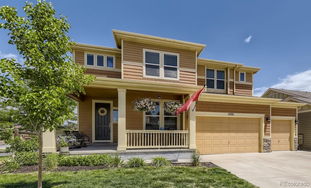 17021 White Alba Lane Parker, CO 80134 - Photo 1 of 21 a front view of a house with a garden