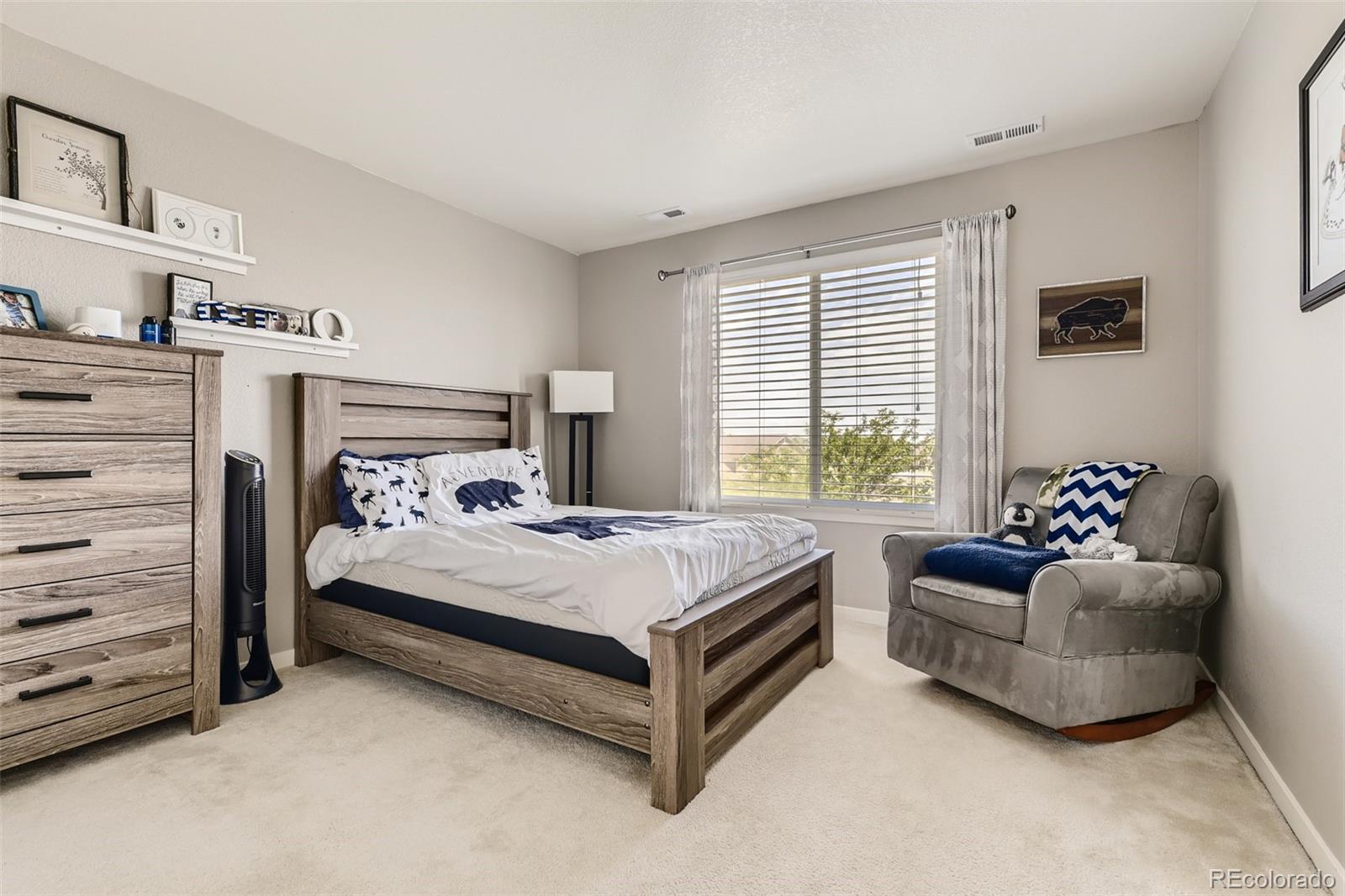 17021 White Alba Lane Parker, CO 80134 - Photo 13 of 21 a bed room with a bed and a couch
