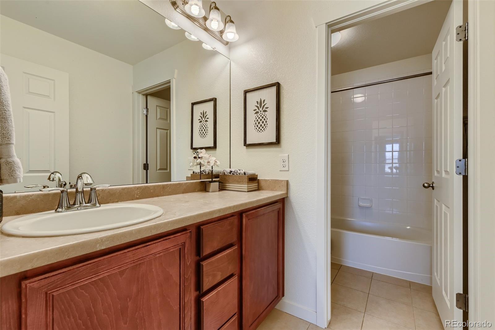 17021 White Alba Lane Parker, CO 80134 - Photo 16 of 21 a bathroom with a sink double vanity granite tub shower and a mirror