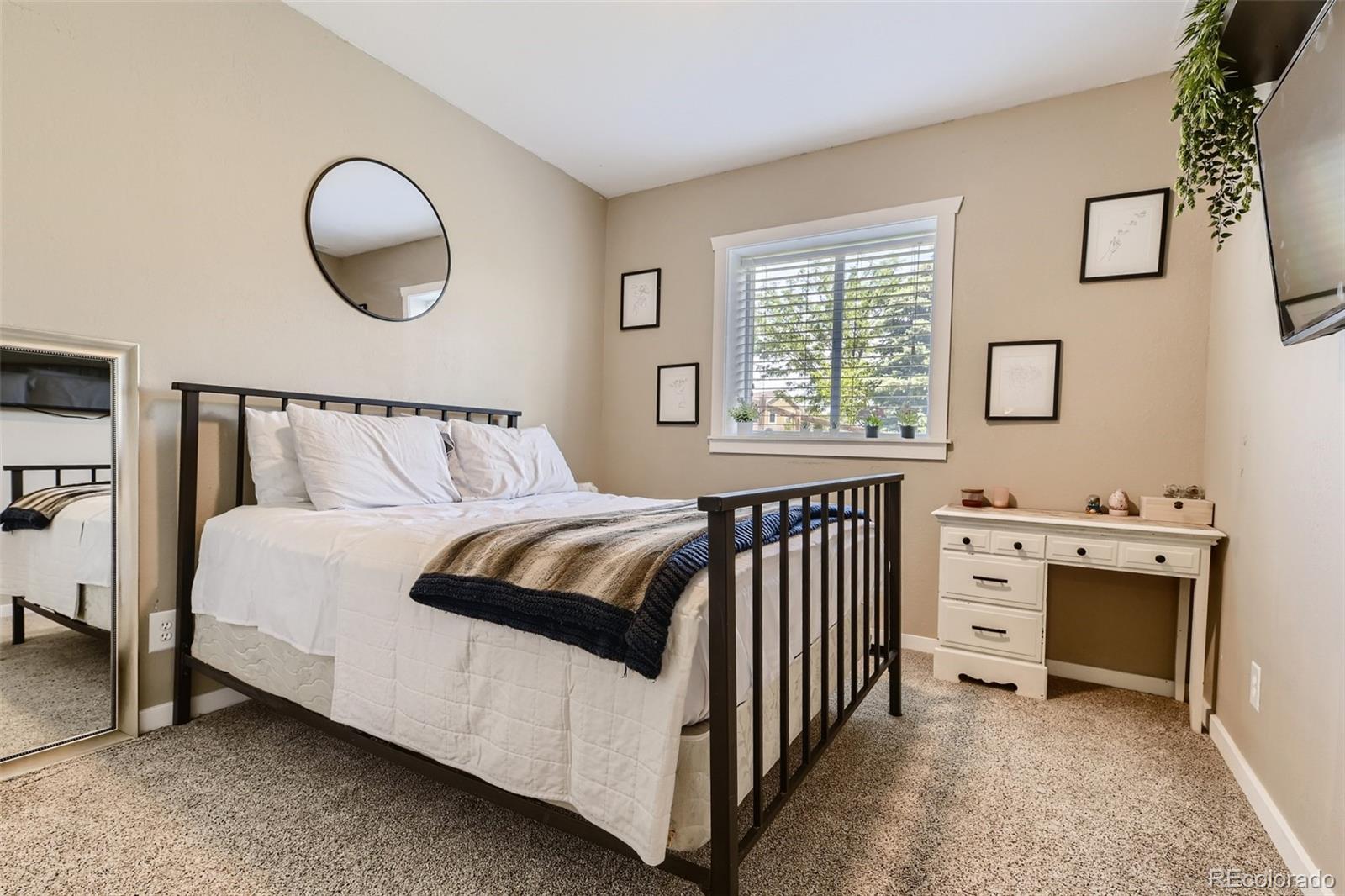 17021 White Alba Lane Parker, CO 80134 - Photo 18 of 21 a bedroom with a bed and a window