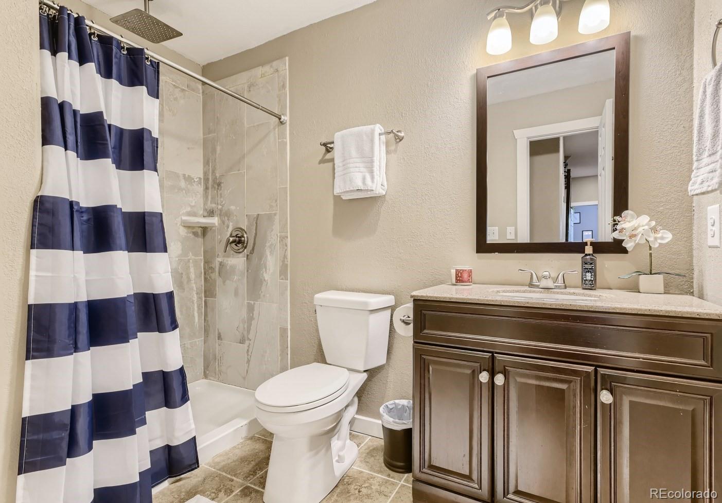 17021 White Alba Lane Parker, CO 80134 - Photo 19 of 21 a bathroom with a sink and a mirror