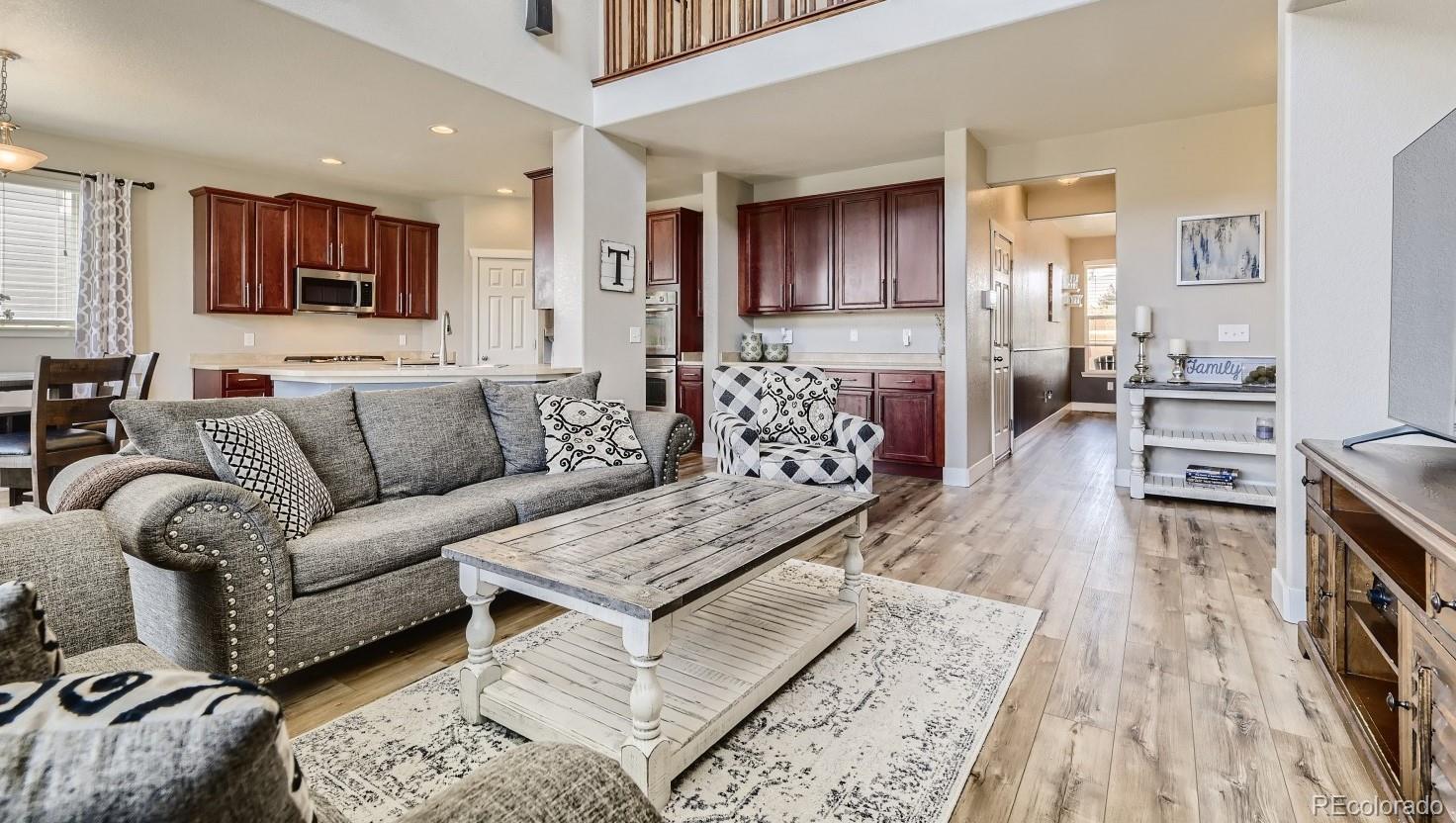 17021 White Alba Lane Parker, CO 80134 - Photo 4 of 21 a living room with furniture and a wooden floor