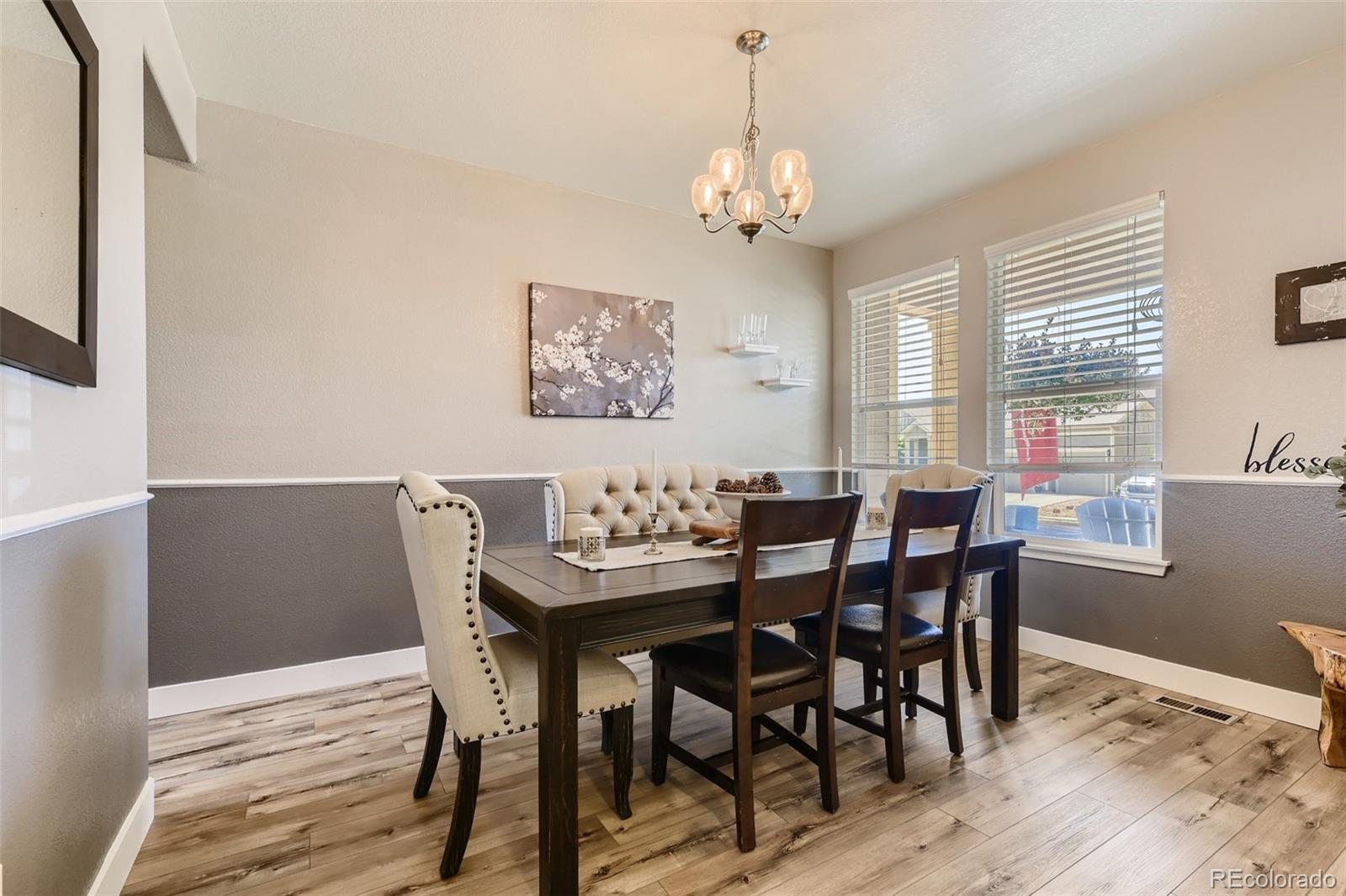 17021 White Alba Lane Parker, CO 80134 - Photo 6 of 21 a view of a dining room with furniture window and wooden floor