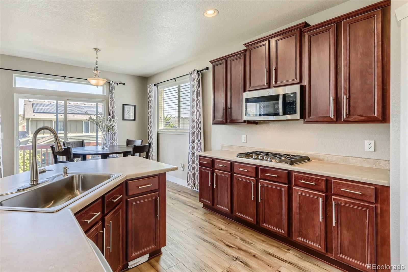 17021 White Alba Lane Parker, CO 80134 - Photo 8 of 21 a kitchen with stainless steel appliances granite countertop a sink stove and microwave