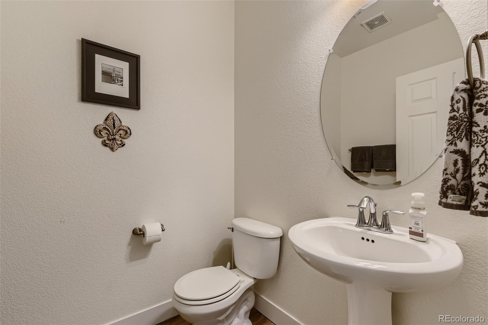 17021 White Alba Lane Parker, CO 80134 - Photo 10 of 21 a bathroom with a toilet sink and mirror