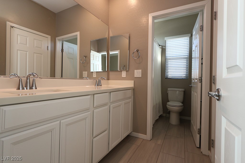 764 Rogue Wave Street Las Vegas, NV 89138 - Photo 14 of 36 Bathroom featuring double vanity and curtained shower