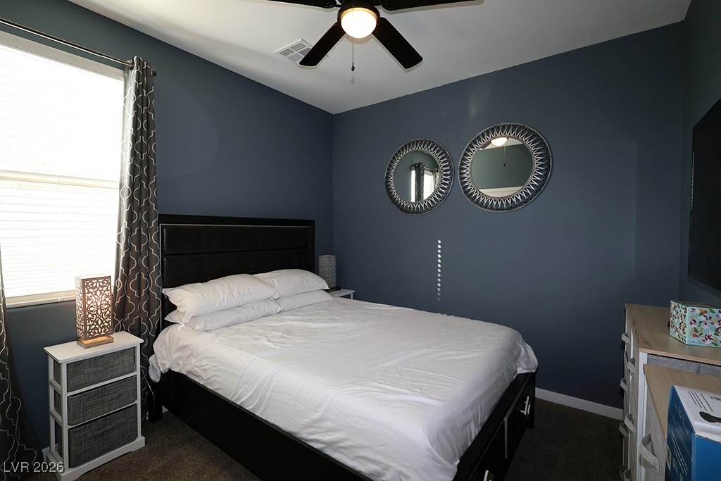 764 Rogue Wave Street Las Vegas, NV 89138 - Photo 26 of 36 Bedroom with dark carpet and a ceiling fan