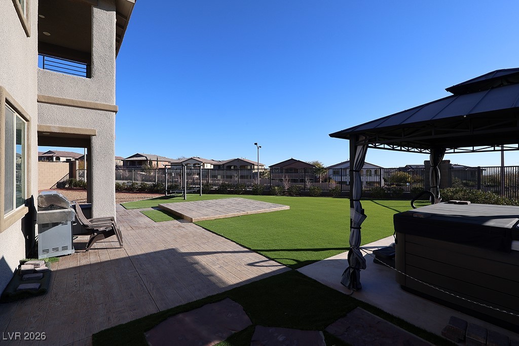 764 Rogue Wave Street Las Vegas, NV 89138 - Photo 29 of 36 Fenced backyard with a patio area, a residential view, a hot tub, and a gazebo