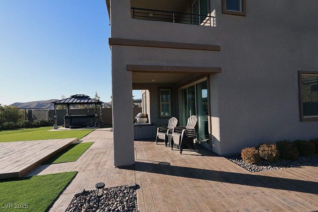 764 Rogue Wave Street Las Vegas, NV 89138 - Photo 31 of 36 Patio / terrace with a hot tub, a gazebo, a fenced backyard, and a deck