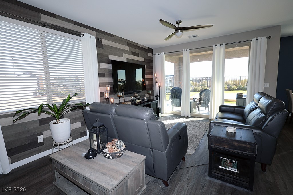 764 Rogue Wave Street Las Vegas, NV 89138 - Photo 10 of 36 Living room featuring an accent wall, wood finished floors, a ceiling fan, and wallpapered walls
