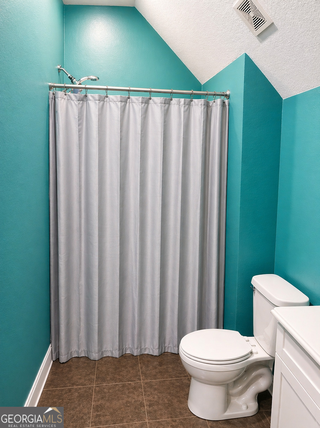 1024 Holly Estates Road Tarrytown, GA 30470 - Photo 13 of 15 a bathroom with a toilet and a shower curtain