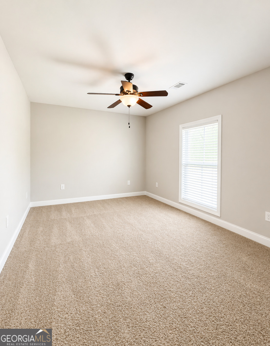 1024 Holly Estates Road Tarrytown, GA 30470 - Photo 8 of 15 wooden floor in an empty room with a window