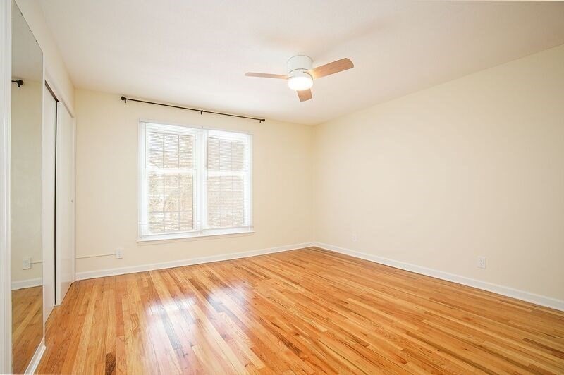 58 Williamsburg Drive, Unit 58 Springfield, MA 01108 - Photo 12 of 15 a view of an empty room with wooden floor and a window
