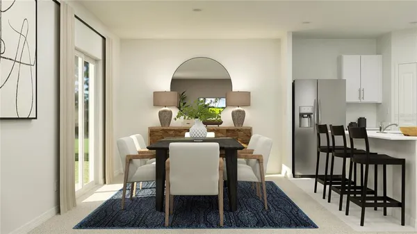 a view of a dining room with furniture and a rug