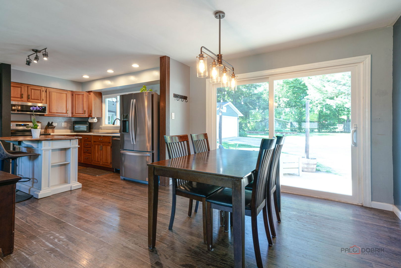 489 1st Street Antioch, IL 60002 - Photo 8 of 33 a kitchen with stainless steel appliances granite countertop a stove a refrigerator a kitchen island a table and chairs