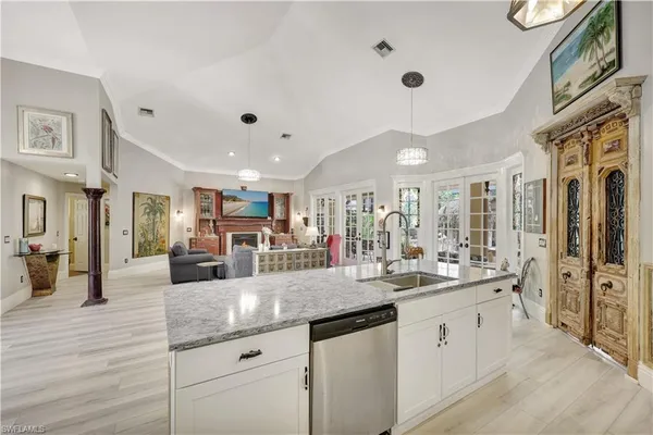 a large white kitchen with a large counter space