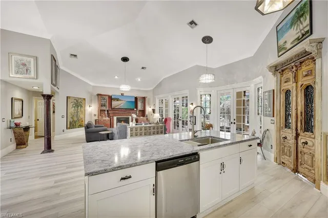 a large white kitchen with a large counter space