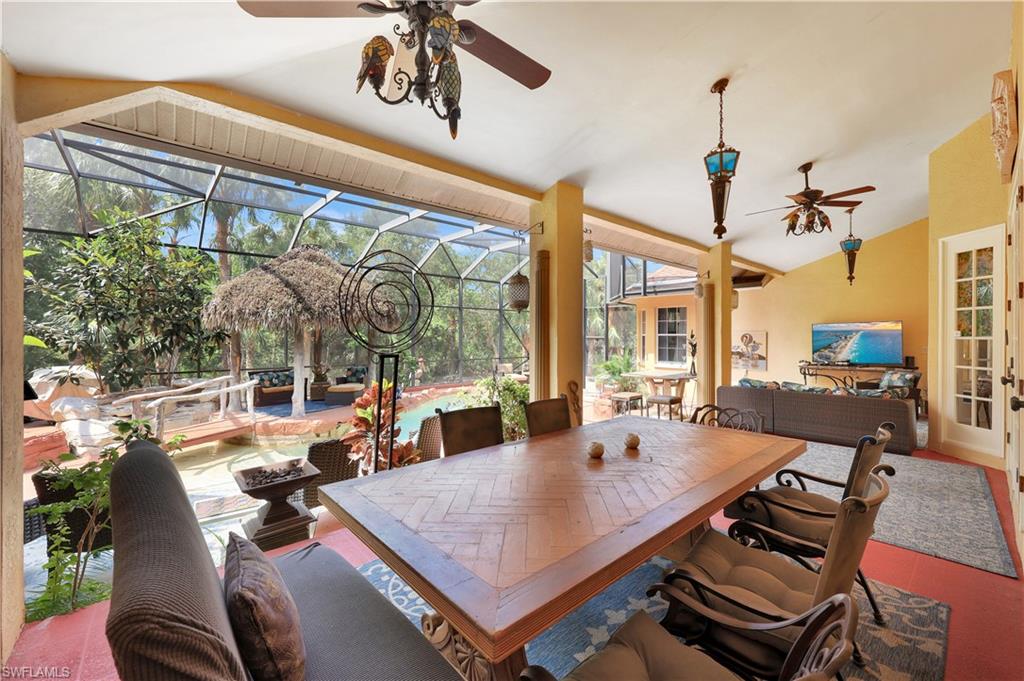 1904 Bethany Place Naples, FL 34109 - Photo 12 of 26 a dining room with furniture a chandelier and a rug