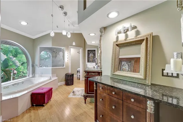 a spacious bathroom with a granite countertop tub sink and a large mirror