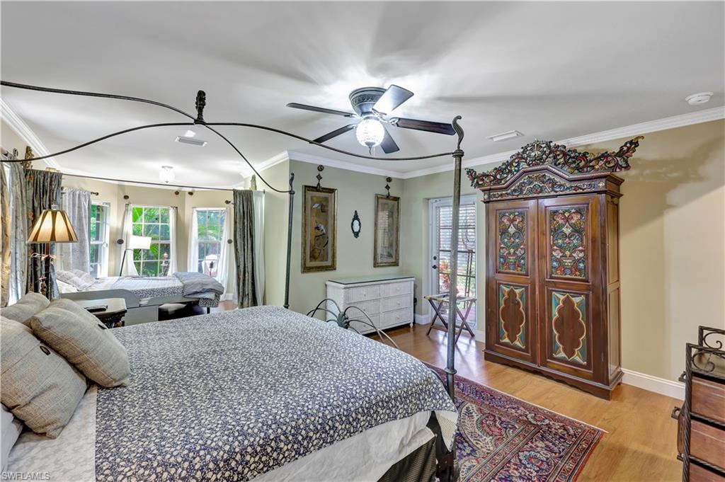 1904 Bethany Place Naples, FL 34109 - Photo 15 of 26 a bed room with a bed and a chandelier