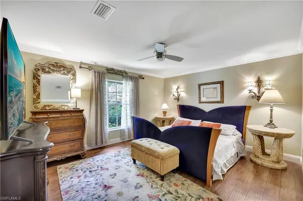 a bedroom with furniture and a window