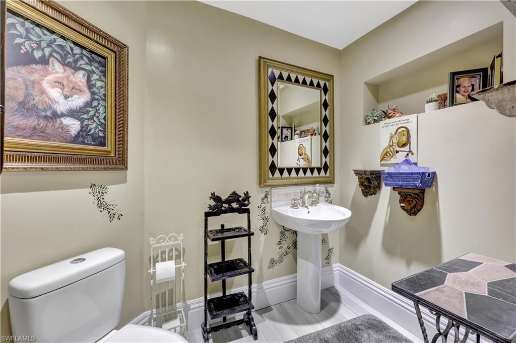1904 Bethany Place Naples, FL 34109 - Photo 17 of 26 a bathroom with a toilet and a sink
