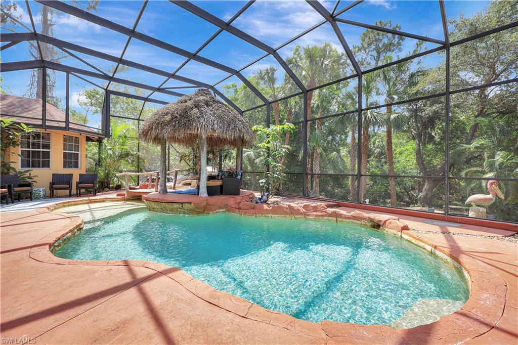 1904 Bethany Place Naples, FL 34109 - Photo 2 of 26 a view of a swimming pool with a patio