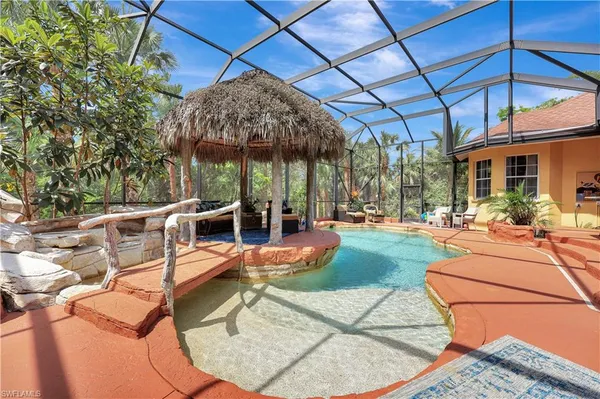 a view of a patio with a table and chairs under an umbrella