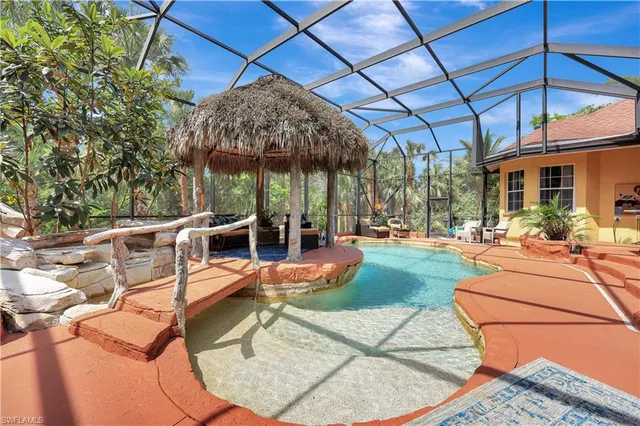 a view of a patio with a table and chairs under an umbrella